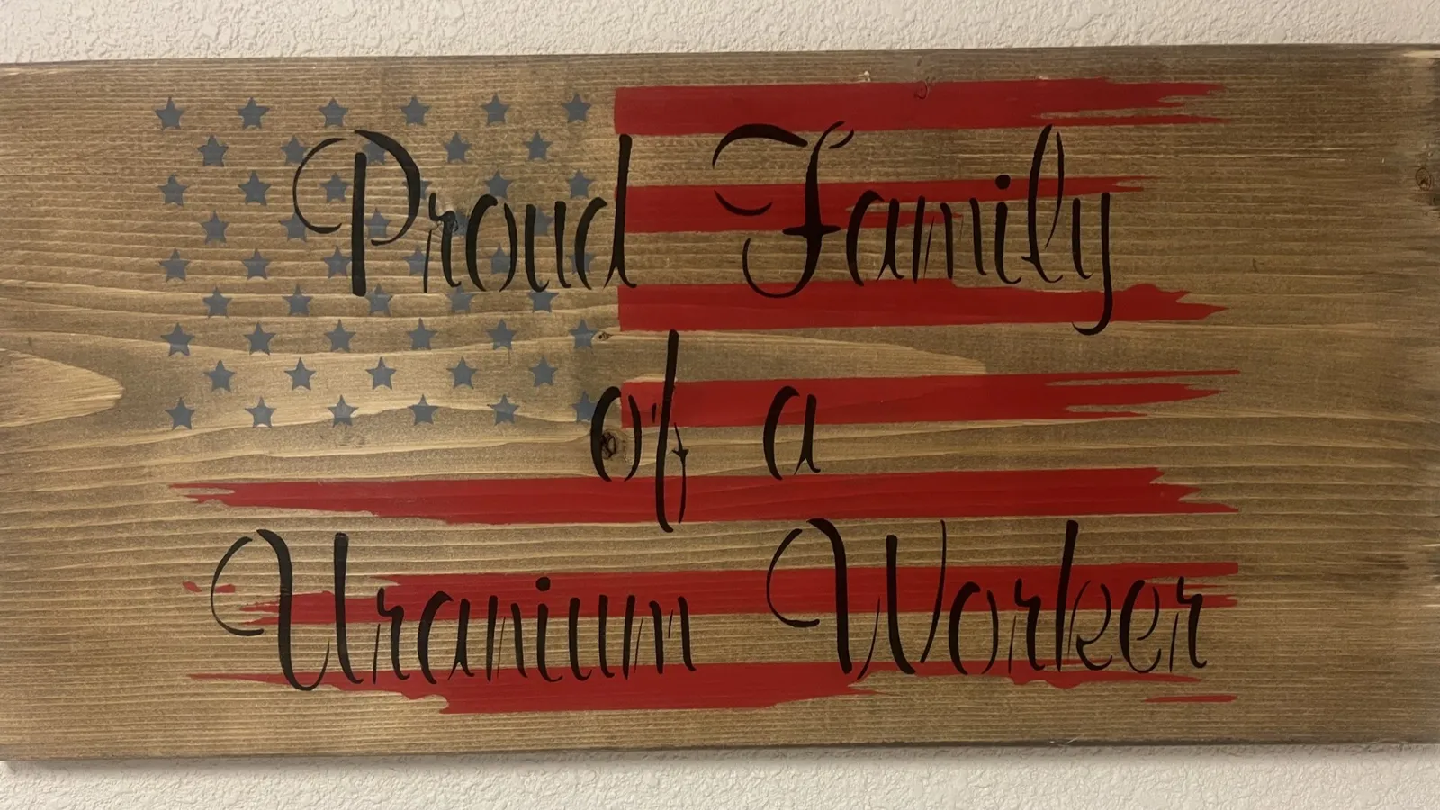 Proud family of a uranium worker, rustic wood sign